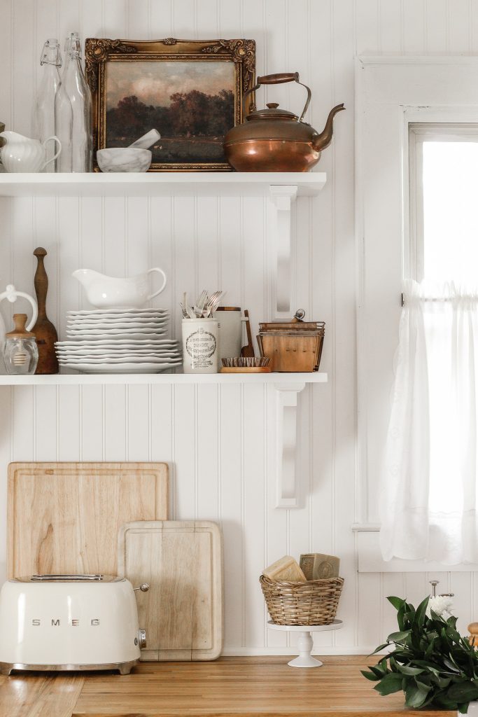 white beadboard backsplash butcherblock countertops corbels open shelves cream smeg toaster and white vintage dishwater