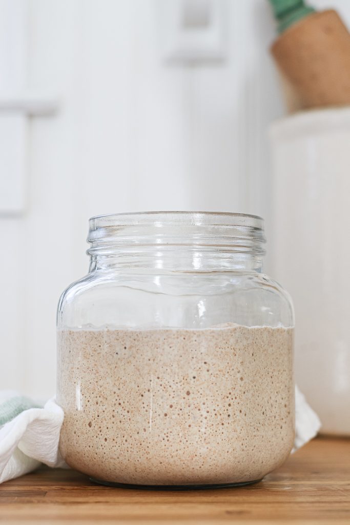 bubbly sourdough starter in glass jar
