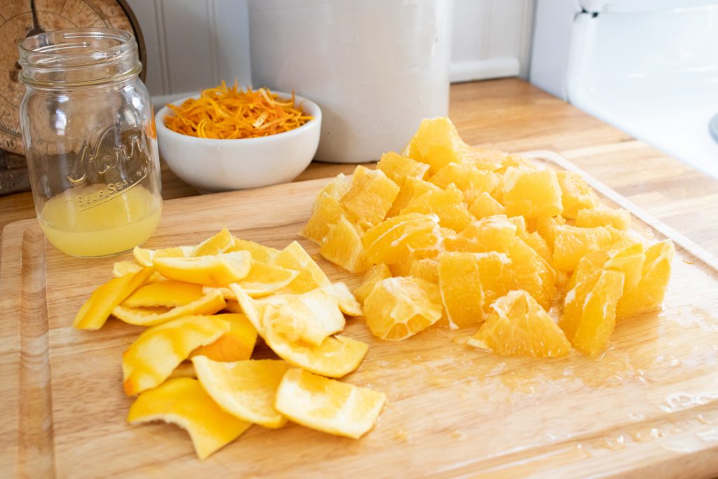 cut oranges sitting on cutting board ready for making marmalade