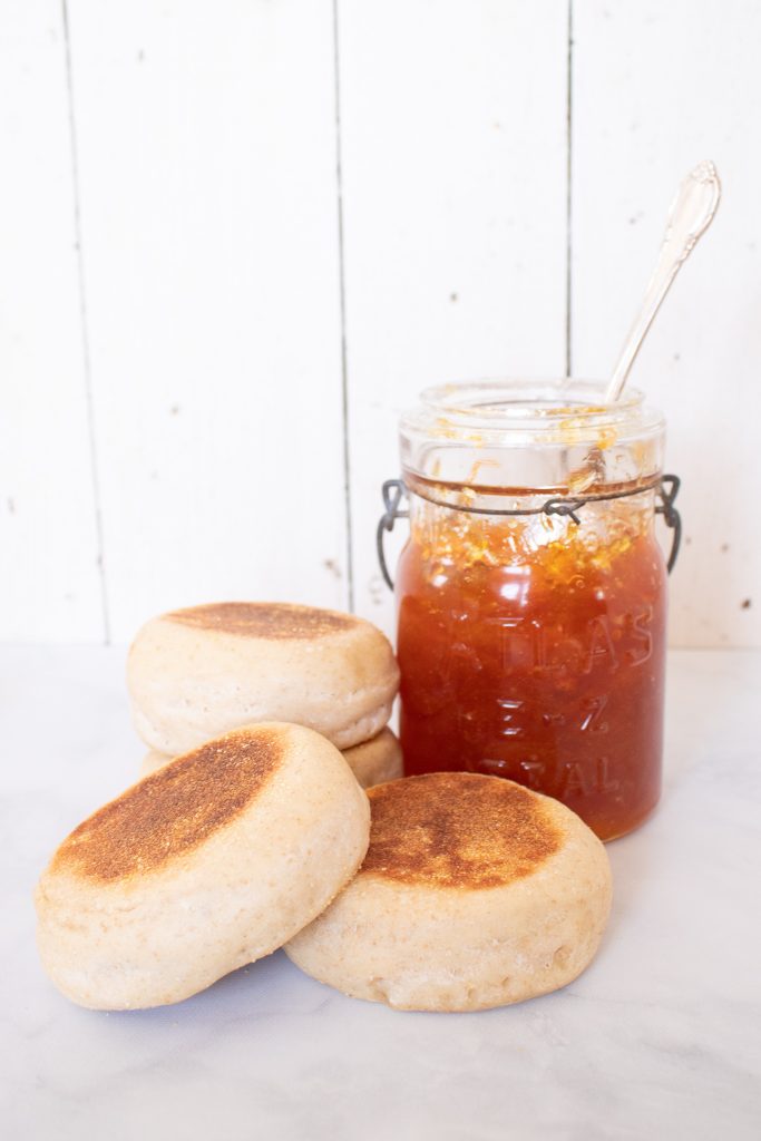 fresh fluff English muffins stacked beside homemade orange marmalade