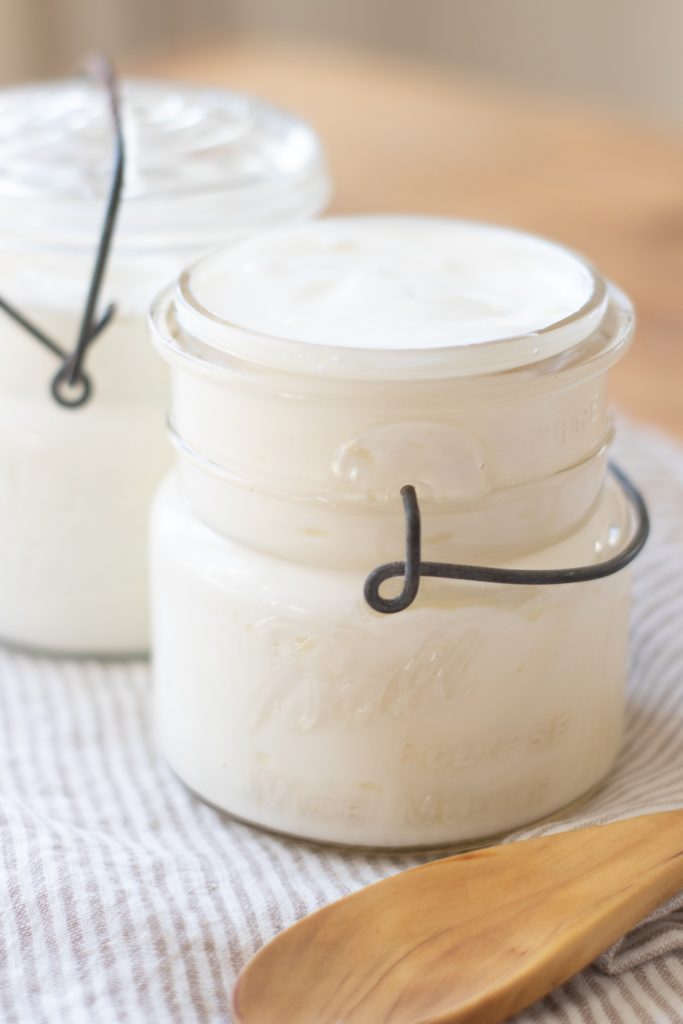 thick creamy raw milk yogurt in a glass mason jar