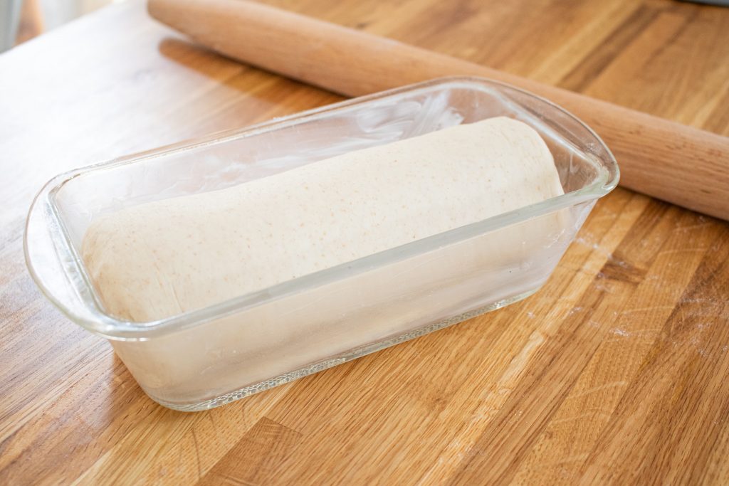 Bread dough in glass pan before proofing